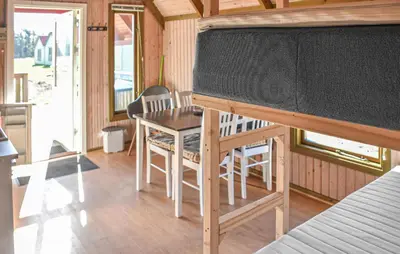 a large screen in a room with a table and chairs at 1 Bedroom Cozy Home In Hanstholm in Hanstholm