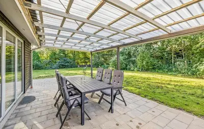 a patio with a table and chairs under a pergola at Gorgeous Home In Farsø With Wifi in Farsø
