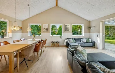 a dining room and living room with a table and chairs at Gorgeous Home In Farsø With Wifi in Farsø