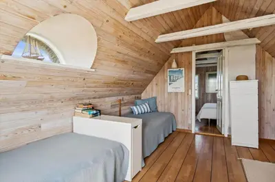 two beds in a room with wooden walls at BL1146-Saltum-Kalundborgvej-25 in Saltum