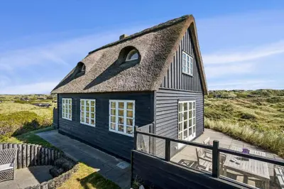 a black house with a thatched roof at BL1146-Saltum-Kalundborgvej-25 in Saltum