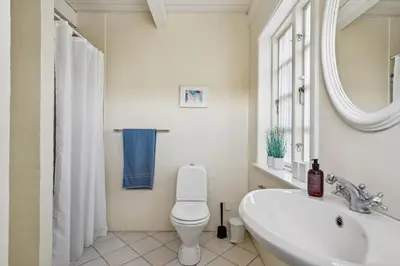 a bathroom with a toilet and a sink and a mirror at BL1146-Saltum-Kalundborgvej-25 in Saltum
