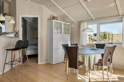 a kitchen and dining room with a table and chairs at JB368-Fjerritslev-Ahornvej-38