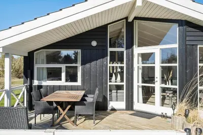 a cabin with a table and chairs on a deck at JB368-Fjerritslev-Ahornvej-38