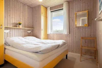 a bed in a room with a window at LK2201-Lokken-Kristavej-45 in Grønhøj