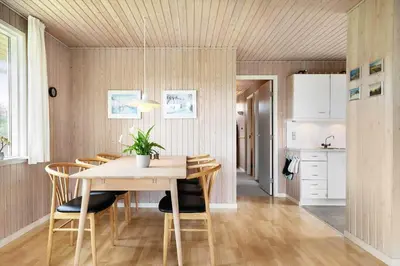 a kitchen and dining room with a table and chairs at LK2201-Lokken-Kristavej-45 in Grønhøj