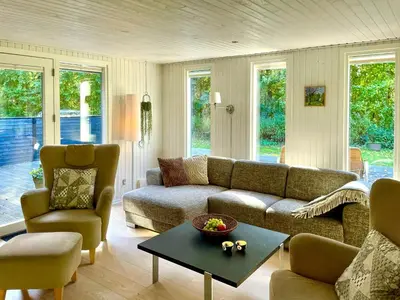 a living room with a couch and a table at Nature Retreat With Fjord Views Near Spøttrup in Spottrup
