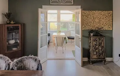 a living room with a table and a dining room at Nice Home In Thyholm With Wifi in Thyholm
