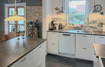 a kitchen with white cabinets and a sink and a window at Nice Home In Thyholm With Wifi in Thyholm