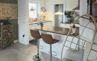 a kitchen with a counter and chairs in it at Nice Home In Thyholm With Wifi in Thyholm