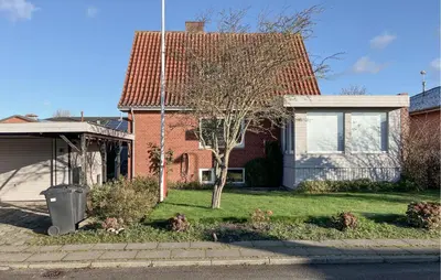 a house with a tree in the front yard at 3 Bedroom Cozy Home In Bøvlingbjerg in Bøvlingbjerg