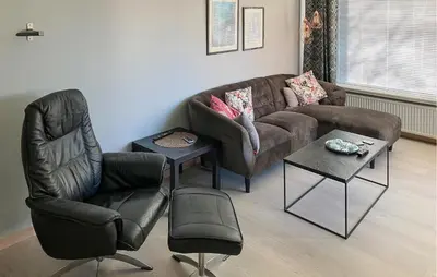 a living room with a brown couch and two chairs at 3 Bedroom Cozy Home In Bøvlingbjerg in Bøvlingbjerg
