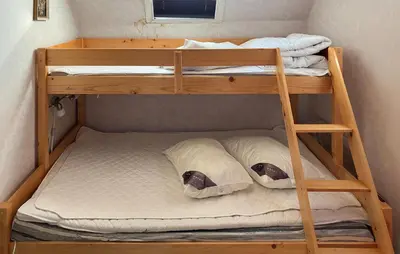 a bunk bed room with two bunk beds with pillows at 3 Bedroom Cozy Home In Bøvlingbjerg in Bøvlingbjerg