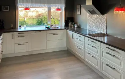 a kitchen with white cabinets and a sink and a window at 3 Bedroom Cozy Home In Bøvlingbjerg in Bøvlingbjerg