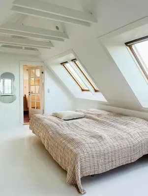 a bedroom with a bed in a white room with skylights at Villa With Fjord View By Frederik Vii's Canal in Løgstør