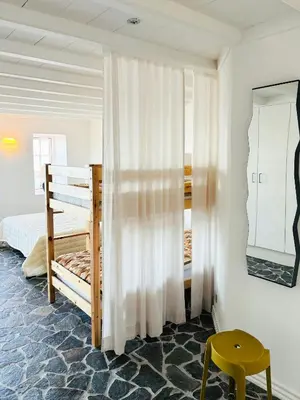 a bedroom with two bunk beds and a yellow stool at Villa With Fjord View By Frederik Vii's Canal in Løgstør