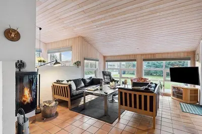 a living room with a couch and a fireplace at BL1144-Blokhus-Sixtusvej-27 in Blokhus