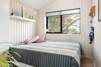 a bedroom with a bed in a room with a window at 1071-Thisted-Gravsesvej-30 in Klitmøller
