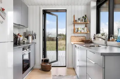 a kitchen with a sink and a large window at 1071-Thisted-Gravsesvej-30 in Klitmøller