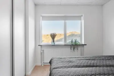 a bedroom with a bed and a window at 729-Thyboron-Vesterhavsgade-112 in Thyborøn