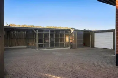 an empty parking lot with a building with a garage at 729-Thyboron-Vesterhavsgade-112 in Thyborøn