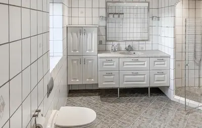 a white bathroom with a toilet and a sink at 6 Bedroom Awesome Home In Hurup Thy in Tvolm
