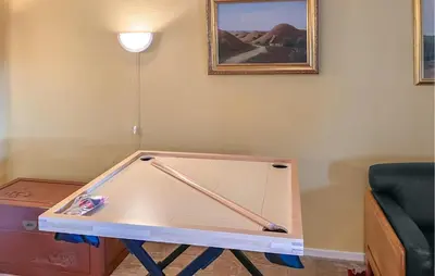 a ping pong table in the corner of a room at 6 Bedroom Awesome Home In Hurup Thy in Tvolm