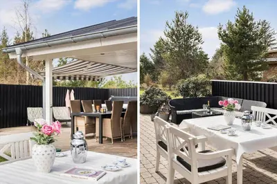 a patio with a white pergola and a table with pink flowers at JB301-Fjerritslev-Landstien-3 in Fjerritslev