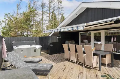 a patio with a table and chairs and a grill at JB301-Fjerritslev-Landstien-3 in Fjerritslev