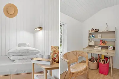a bedroom with a bed and a table with a chair at JB238-Brovst-Baunehojvej-37 in Brovst
