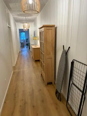 a hallway of a home with a wooden floor and a cabinet at Kildebakkegaard Bed and Breakfast in Nørager