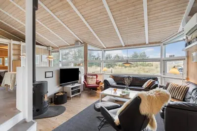 a living room with a couch and a tv at BL1141-Saltum-Faarup-Klitvej-2-A in Saltum