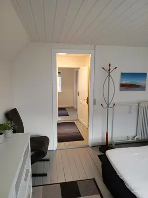 a bedroom with a bed and a hallway at Bolig ved hav og fjord in Thyholm