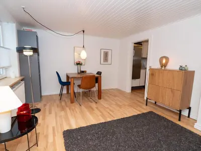 a living room with a table and a dining room at 4 person holiday home in Hanstholm in Hanstholm
