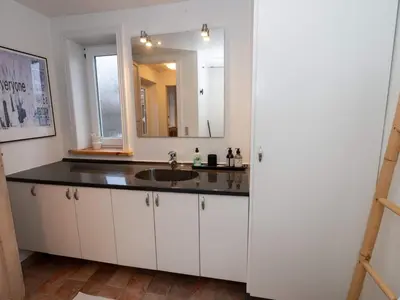 a bathroom with a sink and a mirror at 4 person holiday home in Hanstholm in Hanstholm