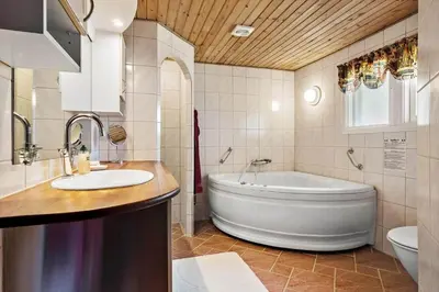 a bathroom with a tub and a sink and a toilet at JB404-Fjerritslev-Jesper-Jensensvej-9 in Slettestrand