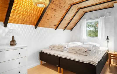 a bed in a bedroom with a wooden ceiling at 2 Bedroom Pet Friendly Home In Thisted in Thisted