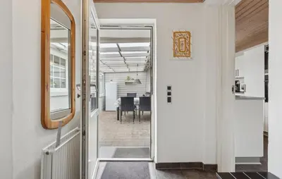 an open door leading to a dining room with a table at Nice Home In Thyborøn With Wifi in Thyborøn