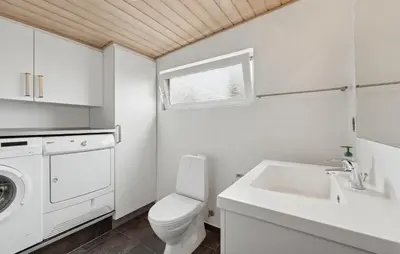 a white bathroom with a toilet and a sink at Nice Home In Thyborøn With Wifi in Thyborøn
