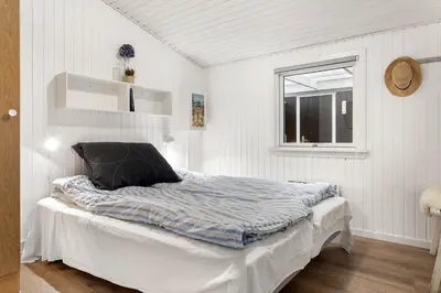 a bed in a room with a window at 741-Thisted-Klemsvej-29 in Nørre Vorupør