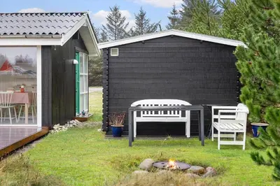 a backyard with a fire pit and two chairs at 741-Thisted-Klemsvej-29 in Nørre Vorupør