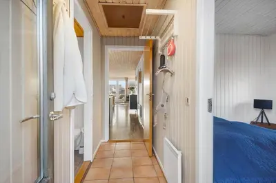 a hallway leading to a bedroom with a bed at 822-Harboore-Neerlandiavej-138 in Harboør