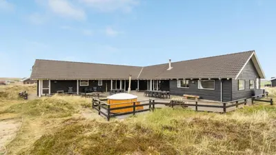 a house on the beach with a fence at Villavilla 176 - Vrist, Vestjylland in Harboør