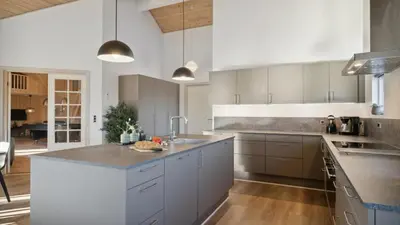 a kitchen with white cabinets and a counter top at Villavilla 176 - Vrist, Vestjylland in Harboør