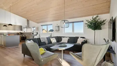 a living room with a couch and a table at Villavilla 176 - Vrist, Vestjylland in Harboør