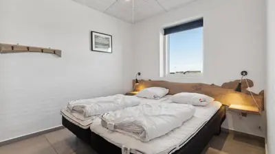 two beds in a room with a desk and a window at Villavilla 607 - Vorupør, Nordjylland in Thisted