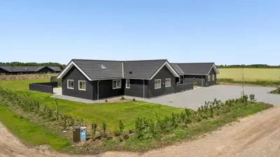 an aerial view of a black house with a driveway at Villavilla 542 - Hostrup Strand, Limfjorden in Spottrup