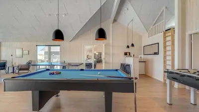 a pool table in a room with two tables at Villavilla 542 - Hostrup Strand, Limfjorden in Spottrup