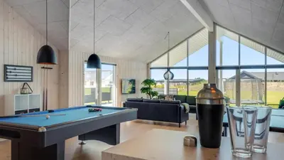 a living room with a pool table and a couch at Villavilla 542 - Hostrup Strand, Limfjorden in Spottrup