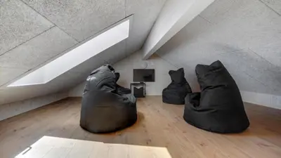 two black chairs sitting on the floor in a room at Villavilla 542 - Hostrup Strand, Limfjorden in Spottrup